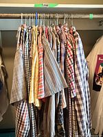 Full view of the row of shirts on closet rod