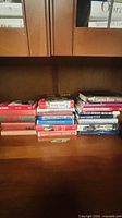 Full view showing two stacks of books on shelf