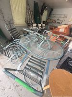 Overall view of table, chairs, lounges and umbrellas