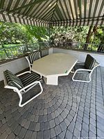 table with four chairs under gazebo