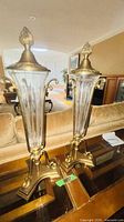 Front view showing both brass and glass urns on table
