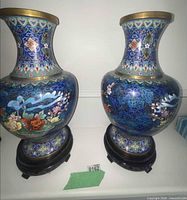 Pair of blue cloisonné enamel vases on wooden bases