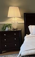 Lamp on bedside table lit, showing overall look with shade
