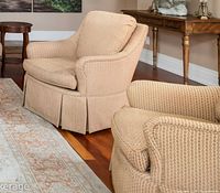 Front and side view of one armchair beside matching chair