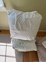 Stack showing two pillow inserts and folded blanket