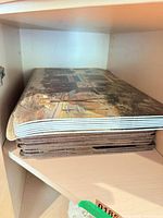 Stack of multiple cork-backed placemats on shelf