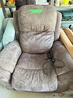 Front view of grey La-Z-Boy powered recliner with remote on seat