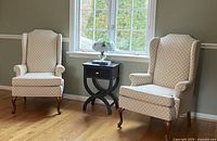 Pair of matching wing chairs in room setting