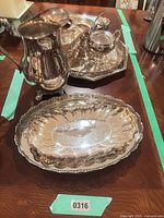 Overview showing pitcher, tray with sugar bowl and creamer, and oval platter