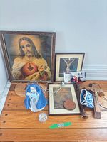 Group shot of framed prints, figurine, crosses, rosary items and wooden pieces