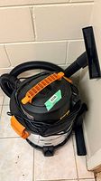 Overall view of vacuum with hose and attachments
