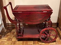 Cart folded with leaves down showing bottle rack, wheels, handle and lower shelf