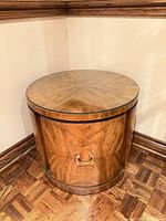 Full view of round wood veneer drum side table with glass top