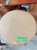 Top view showing round cork surface and clear glass protector with measurement tape