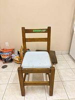 Front view of wooden chair with upholstered seat