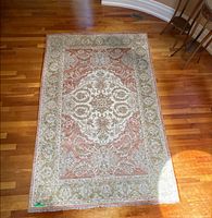 Full view of hand-knotted area rug showing design and size relative to floor
