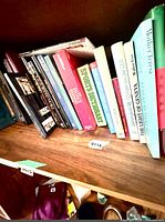 Left section of shelf showing various music score books and other titles