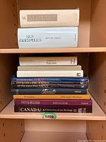 Front view of entire stack of books on shelf