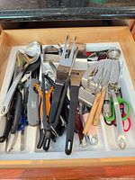 Drawer view showing bulk of mixed utensils