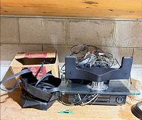 Workbench view of DVR, TV stand on glass base, cables, box