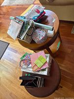 Overall view of gift bags, wrap rolls and tin on tables