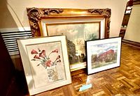All three framed artworks leaning against wall