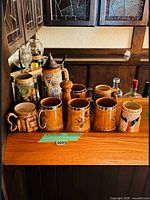 Group view of all steins and pepper mill on wooden bar