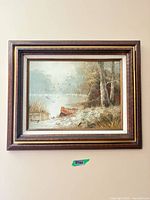 Full view of framed landscape painting on wall