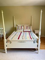 Full view of white four-poster double bed frame assembled