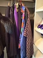 Garments on hangers showing variety of colours and styles