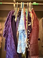 Full view of assorted garments on closet rod