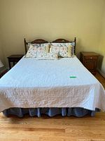 Bed fully made showing frame, headboard and bedside scale