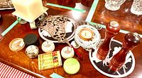 overview of assorted tabletop items including pepper mills, candles, trivet and compass