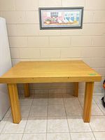 Front view of rectangular wooden table showing top and legs