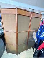 Angled overall view of three-panel wooden room divider