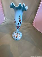 Front view of blue opaline satin glass vase with hand-painted floral decoration