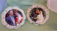 Two decorative ceramic plates with faux crystal rims displayed on stands