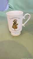 Full view of Holly Hobbie pedestal mug with illustration and inscription