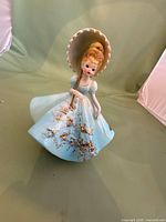Full view of Lefton porcelain lady figurine in blue dress with parasol