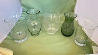 Front view of all five glass hurricane vases displayed side by side