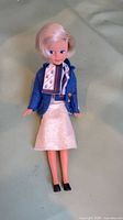 Full view of fashion doll lying flat showing complete outfit