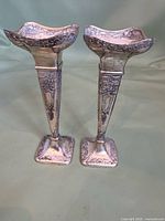 Full view pair of silver-plated bud vases front and side