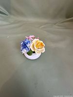 Full view of small Radnor bone china floral posy showing multicolor flowers and white base