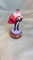 Full view of resin couple figurine on music box base
