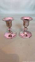 Pair of silver-plated taper candlesticks front view