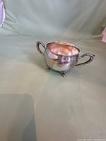 Full view of sugar bowl front with handles and feet
