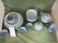 Entire Wedgwood pale blue jasperware tea service laid out showing all components