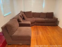 overall L-shaped arrangement of sectional showing five seating pieces and pillows