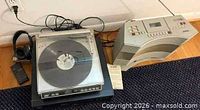 Top view showing turntable with record, headphones, remote, cords and Bose Acoustic Wave unit