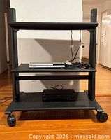 Full view of entertainment stand with devices on shelves